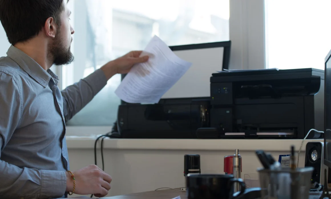 Man using a scanner to digitize a document with OCR